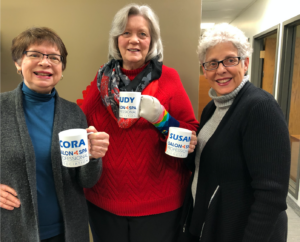 Salon Spa Professional Association members holding personalized mugs
