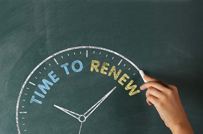 A clock drawn on a chalkboard, with "Time to Renew" written in place of the numbers to indicate an expiring membership.