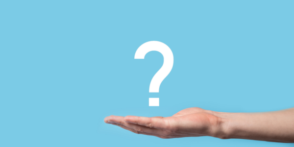 A person extends their hand palm up and holds a question mark against a light blue background, reflecting their curiosity about association management software.