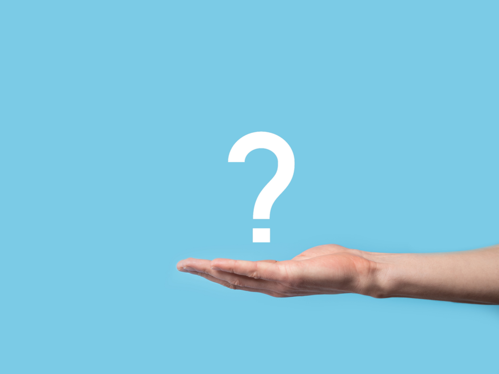 A person extends their hand palm up and holds a question mark against a light blue background, reflecting their curiosity about association management software.