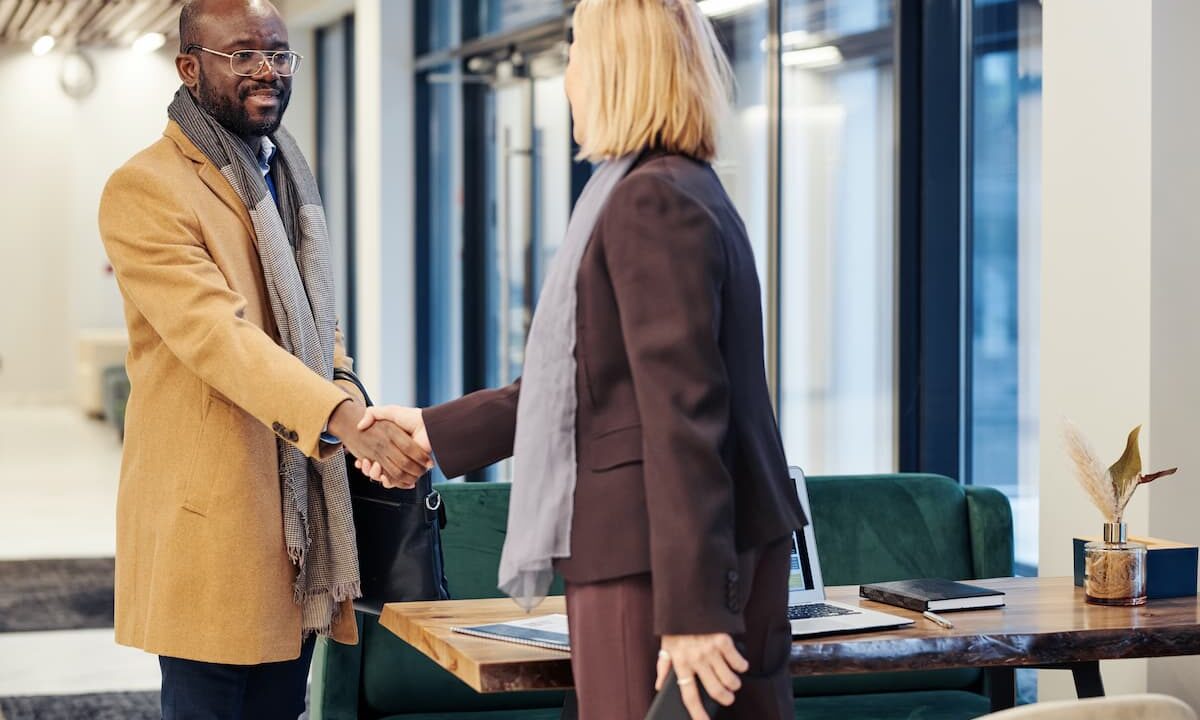 nonprofit leader shaking hands with a new donor