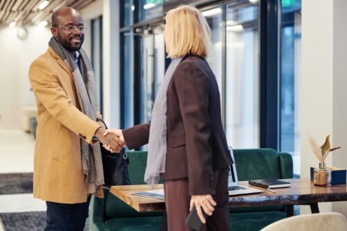 nonprofit leader shaking hands with a new donor