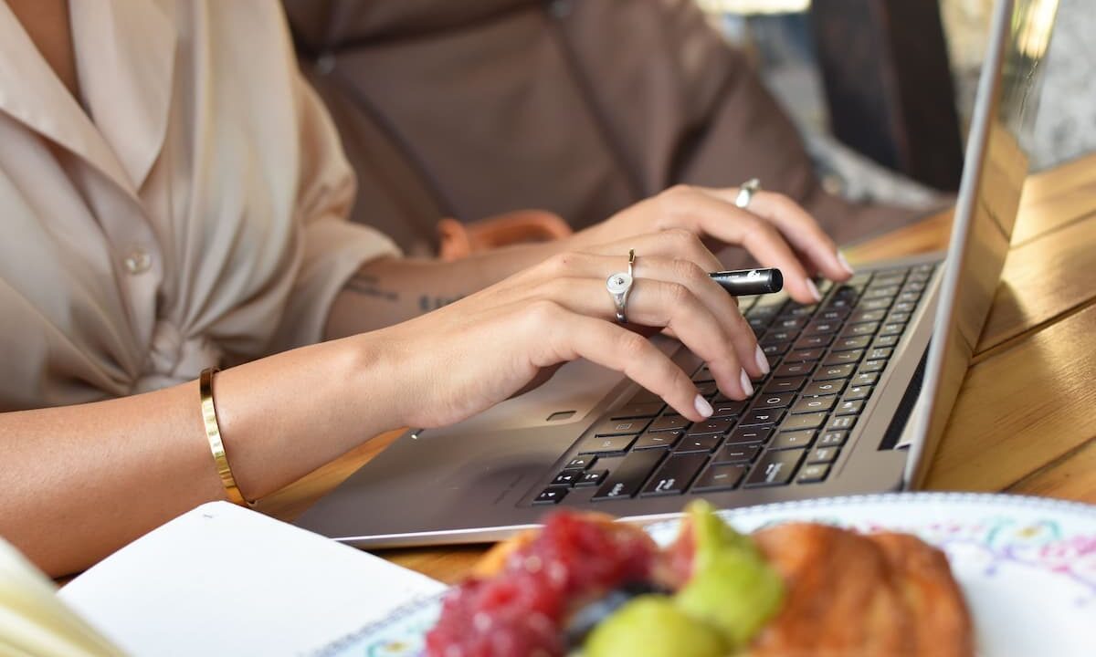 woman writing content on a laptop for her association members