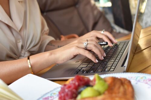 woman writing content on a laptop for her association members