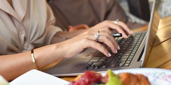 woman writing content on a laptop for her association members