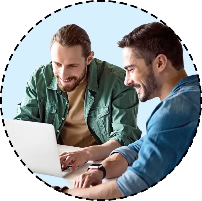 coworkers looking at a laptop together