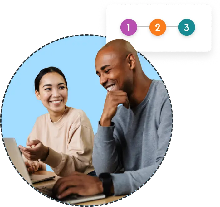 man and woman smiling at a laptop