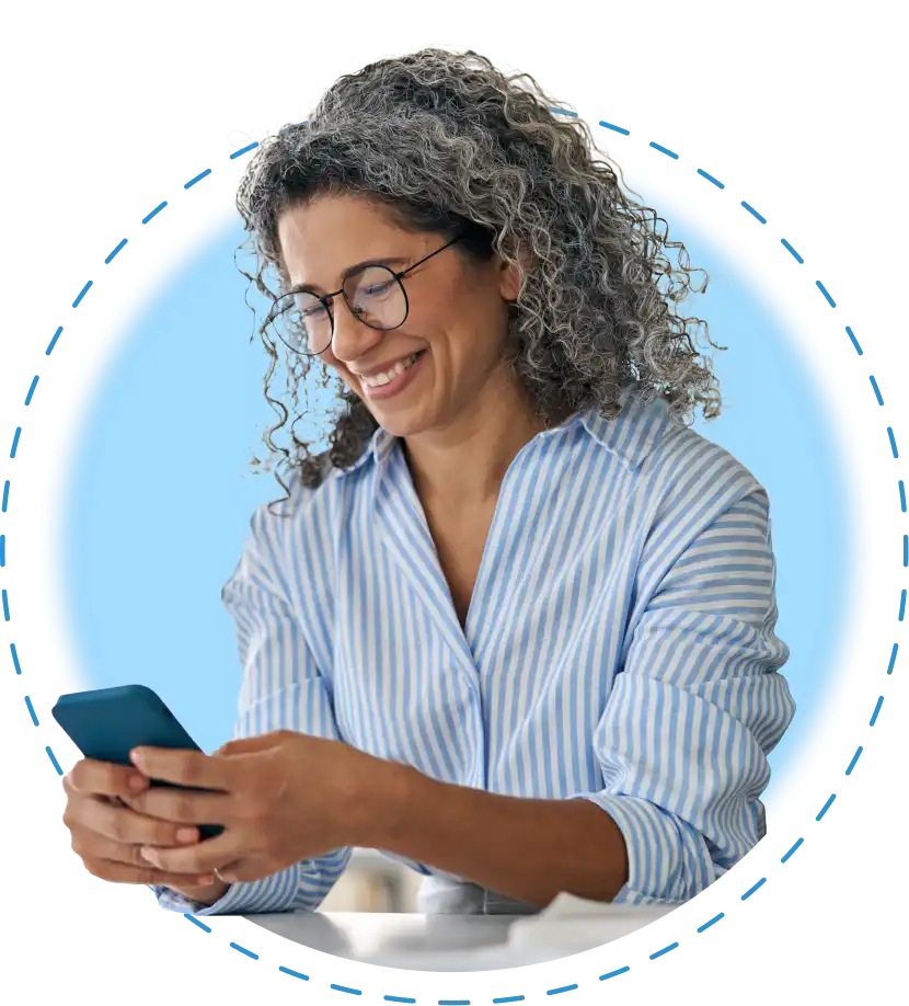 a woman smiling at her phone